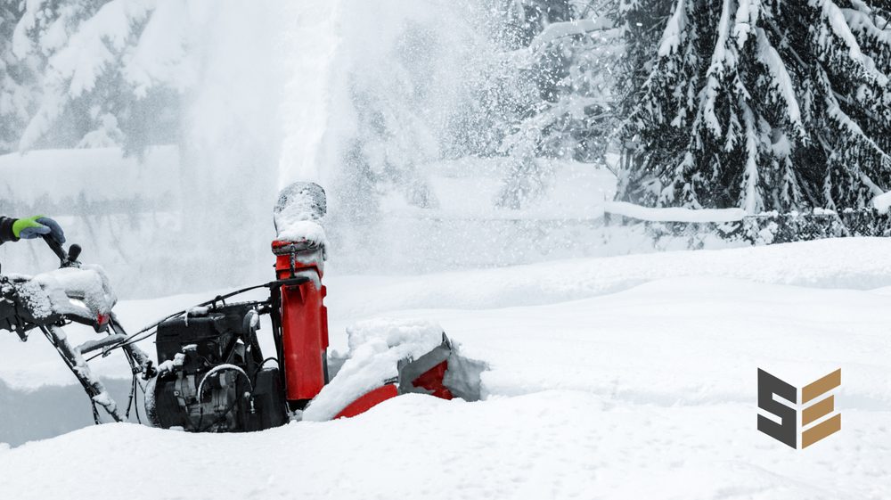 Snowblower clearing a walkway, throwing a plume of snow